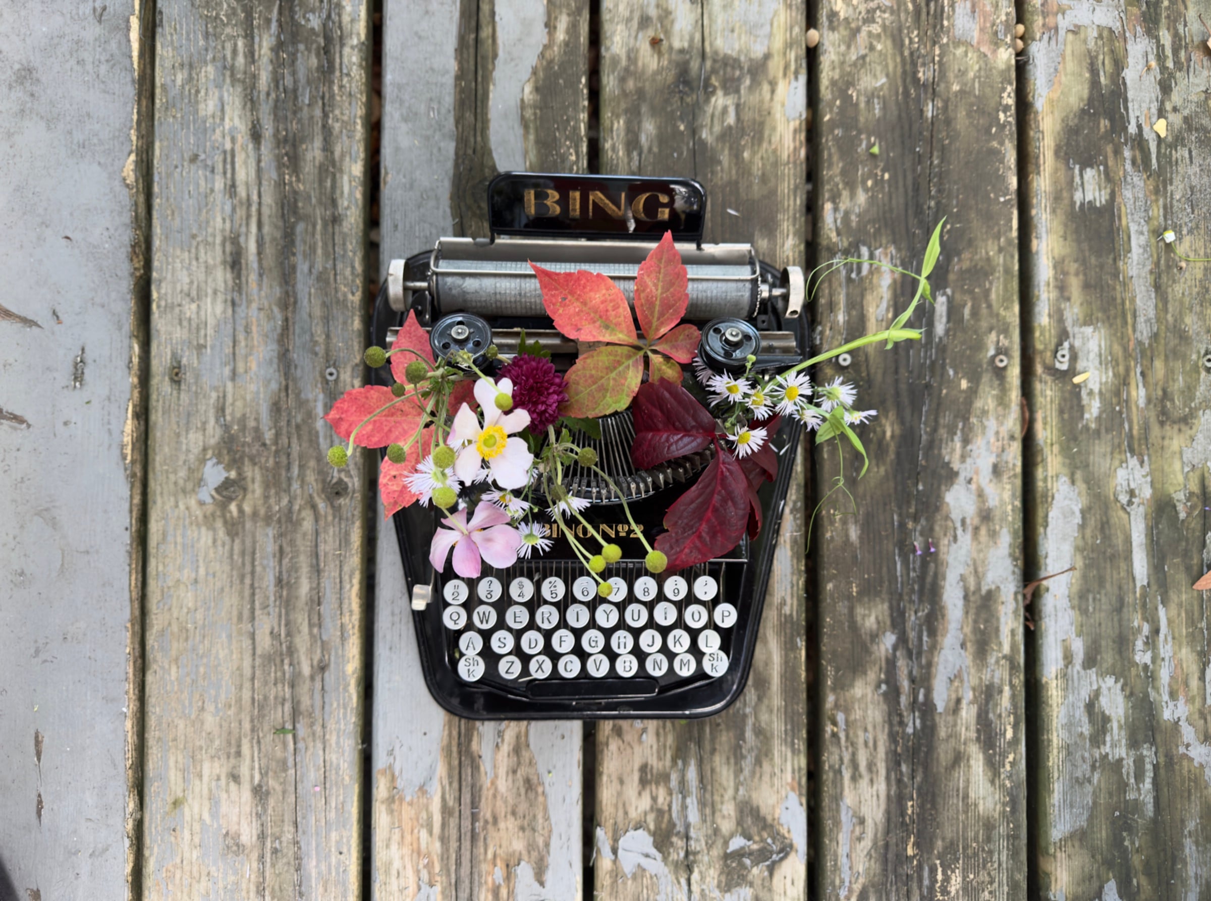 Rustic floral workshop with tools, dried flowers hanging, and soft light